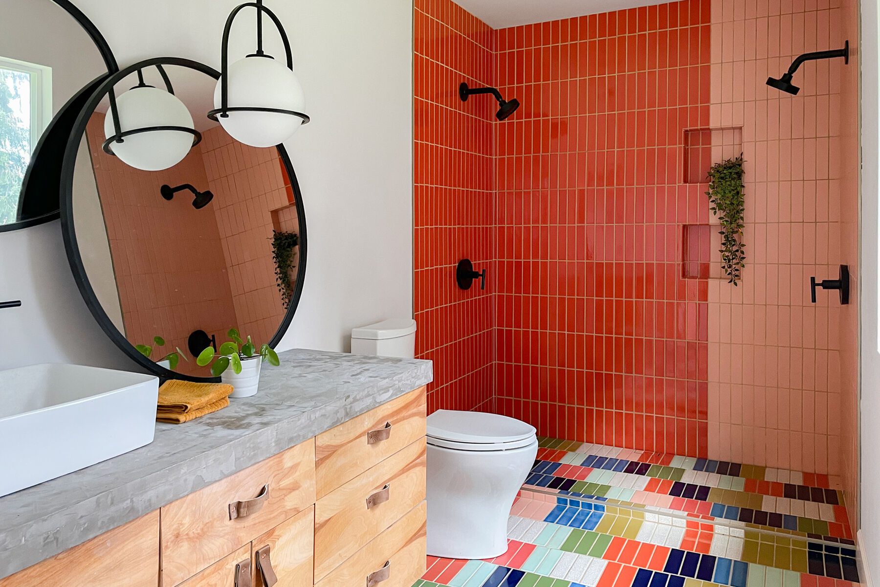 red tile shower wall and multicolored shower floor tile